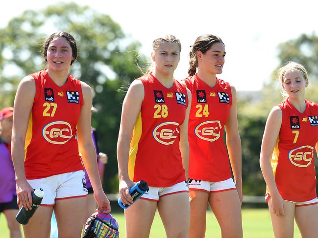 SUNSHINE COAST, AUSTRALIA - SEPTEMBER 19: Dekota Baron, Chloe Gaunt, Georja Davies and Sunny Lappin of the Gold Coast Suns Academy Girls walk off the field after their victory during the AFL U16 Girls match between the Brisbane Lions and the Gold Coast Suns on September 19, 2022 in Sunshine Coast, Australia. (Photo by Albert Perez/AFL Photos via Getty Images)