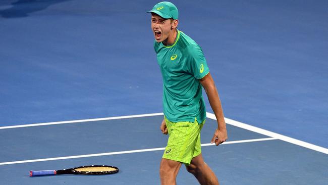 Alex De Minaur celebrates his victory over Milos Raonic.