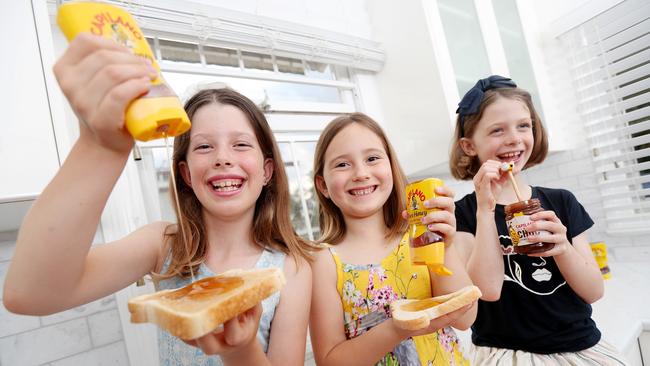 Ella O'Reilly, 10, Eliana Tavian, 5, and Olivia O'Reilly, 8, enjoy Capilano honey. Picture: Tara Croser