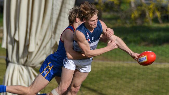 Henley’s Bailey Klemasz is tackled by Old Ignatians’ Will Ferrari when the teams clashed this season. Picture: Brenton Edwards