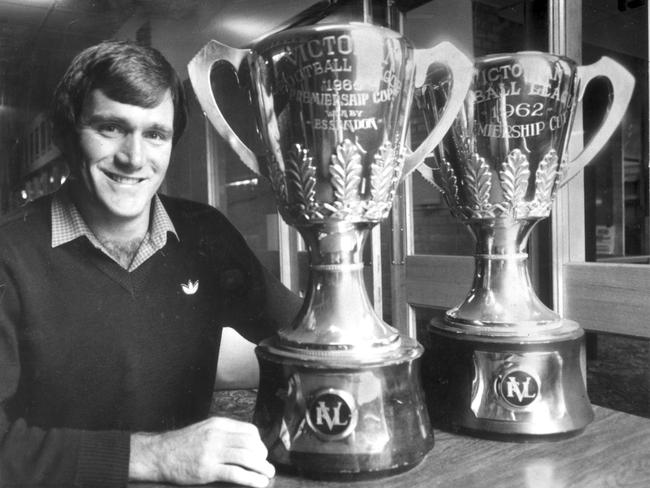 Weston with the premiership cups from 1962 and 1965.