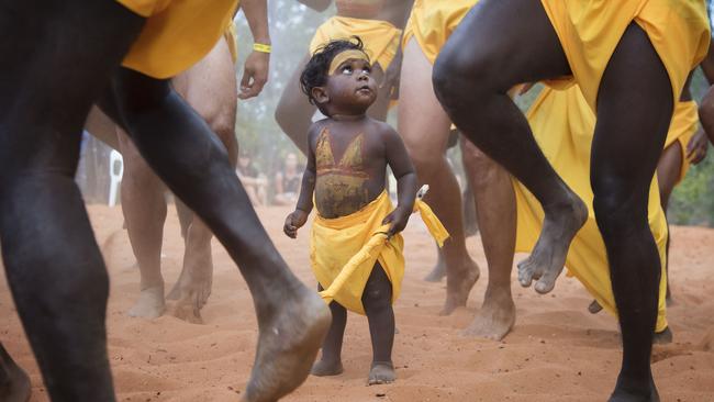 A youngster looks for guidance during a traditional dance session on the opening day of the Garma festival in Arnhem Land. Picture: Melanie Faith Dove