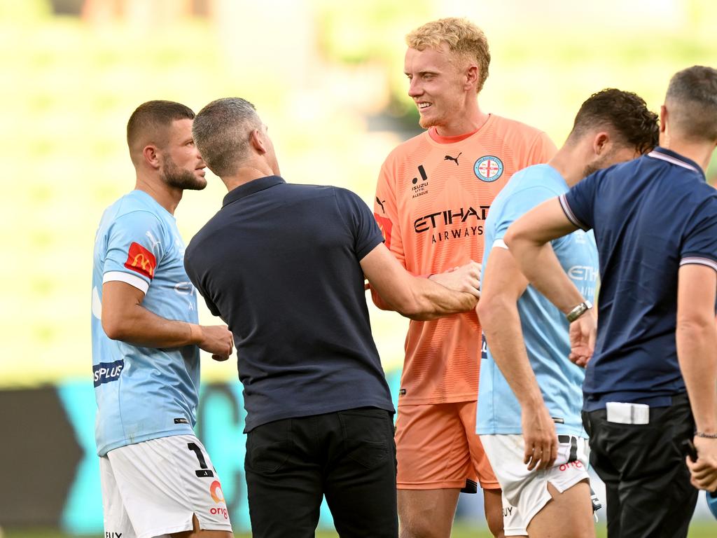 Melbourne City goalkeeper Tom Glover (centre) talks to Mariners coach Nick Montgomery. Picture: Morgan Hancock/Getty Images