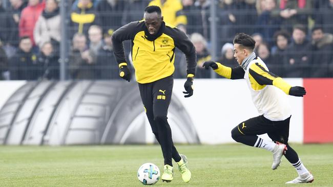Usain Bolt (left) trains with German Bundesliga club Borussia Dortmund in March. Photo: AFP