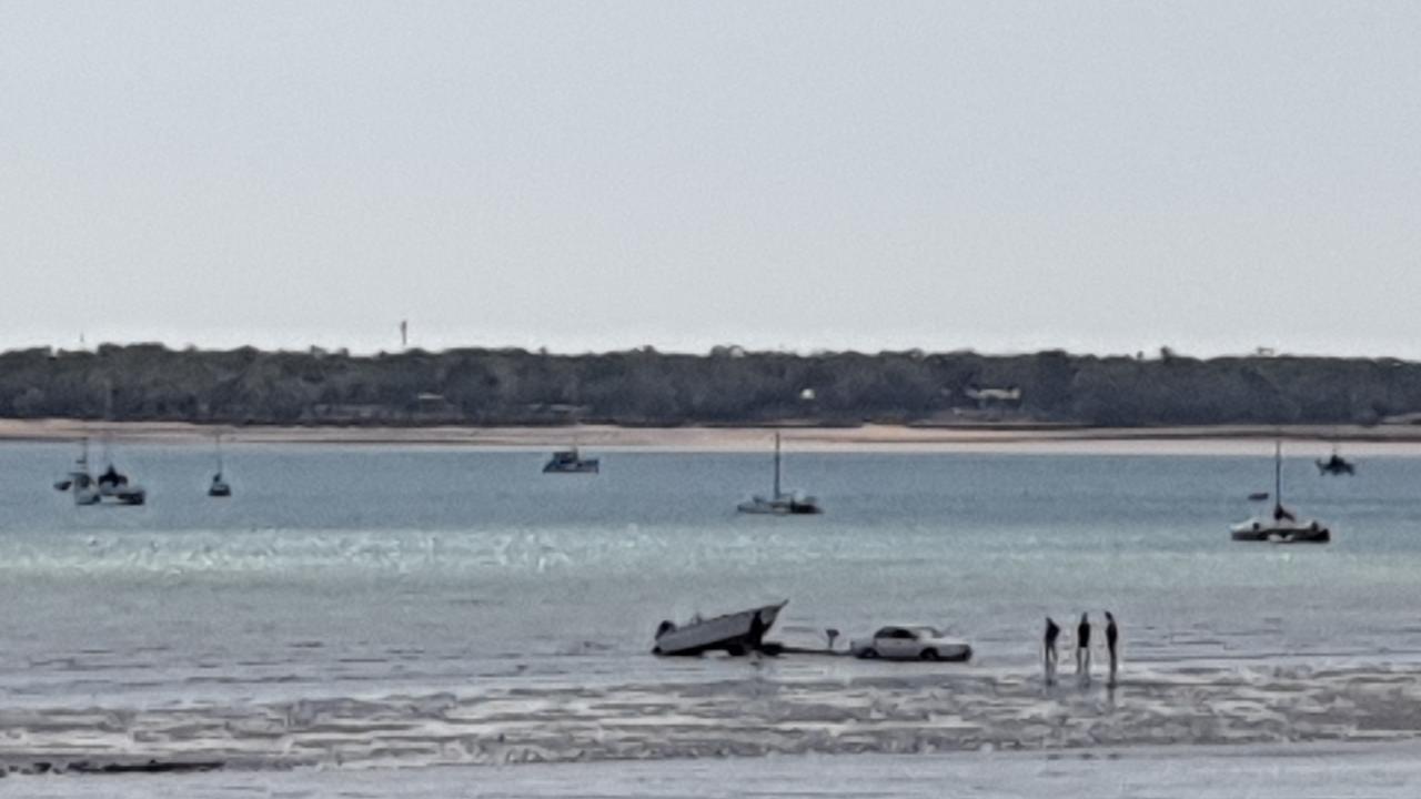 The low tide didn't phase this group, who used what appears to be a Toyota Camry to launch their boat, reversing it across the sand. Picture: David Bateson