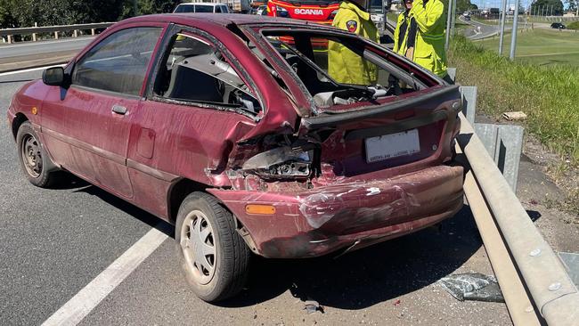 A woman has been taken to hospital after the red Ford hatchback she was driving collided with a truck and then a ute on the Bruce Highway,