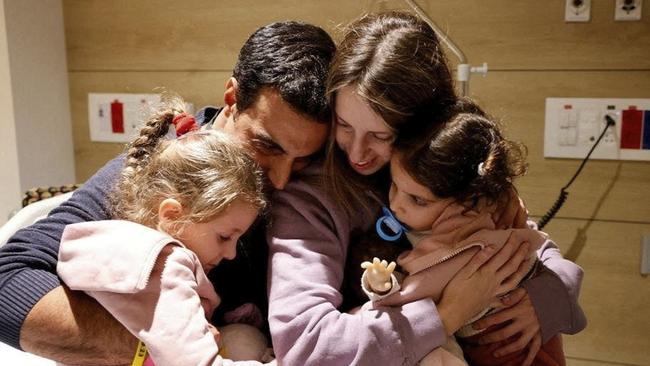 Yoni and Doren Asher and their daughters Raz, left, and Aviv, are reunited after the hostage release in Petah Tikva, Israel. Picture: Reuters