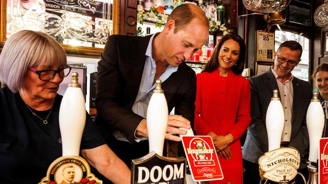 William had a go behind the bar while a smiling Kate watched on. Picture: Jamie Lorriman/Pool/AFP