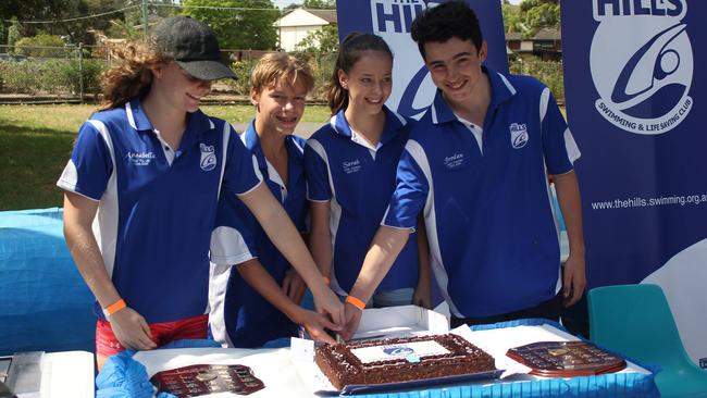 Swimming Club captains, Annabelle Woodbury and Aaron Wartmann, and Life Saving Clubcaptains, Sarah Osborne and Jordan Hodgers, cut the birthday cake at The Hills Swimming and Life Saving Club's 50th anniversary celebrations on February 12. Pictures: Supplied