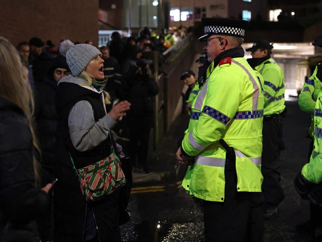 Police contain protesters outside court after the ruling.