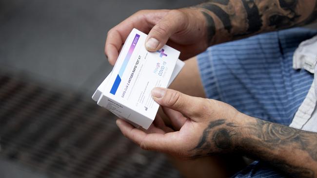 SYDNEY, AUSTRALIA - NewsWire Photos JANUARY 13, 2022: A customer holds his rapid antigen tests after purchasing them from a chemist in Sydney. Australians are dealing with low supplies following the surge in COVID cases across the country. Picture: NCA NewsWire / Nikki Short