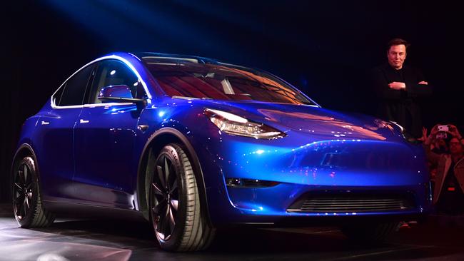 Tesla CEO Elon Musk views the new Tesla Model Y at its unveiling in Hawthorne, California on March 14, 2019. (Photo by Frederic J. BROWN / AFP)