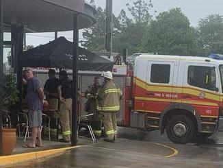 Gympie fire fighters finish testing the air inside Toucan Coffee for any toxic fumes after fire broke out in a coffee machine on Tuesday.