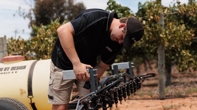 Zane Sheffield of Agtech By Design inspects a spray rig used in an orchard. Picture: Supplied