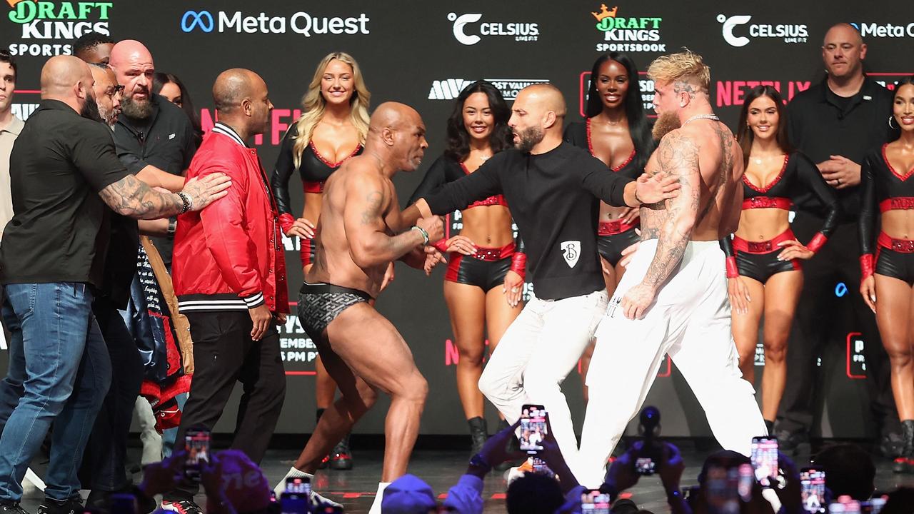 Mike Tyson Strikes Jake Paul in Intense Weigh-In Showdown