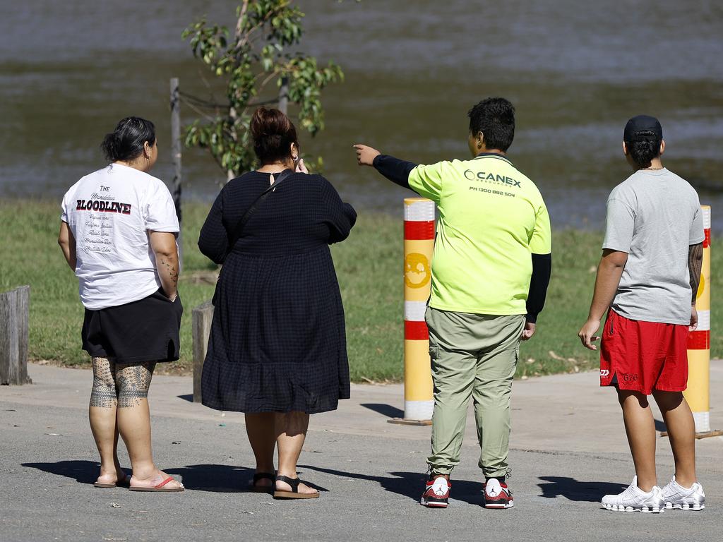 Friends and family pictured as police and emergency services continue the search at the scene in Jindalee where the man went missing. Picture: Josh Woning