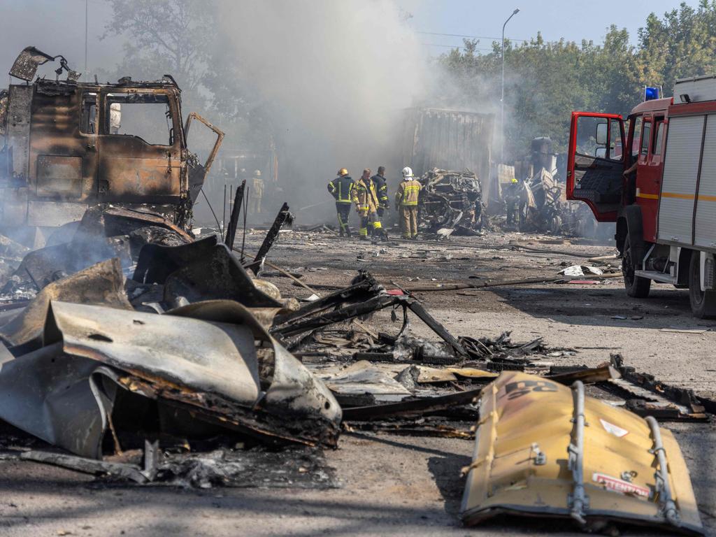 Ukrainian firefighters extinguish a fire on a site following an air attack in the Odesa region.