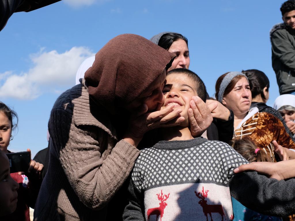 Dilbar Ali Ravu, 10, is kissed by his aunt Dalal Ravu after Yazidi children were reunited with their families in Iraq after five years of captivity with ISIS on March 2, 2019. Picture: AP