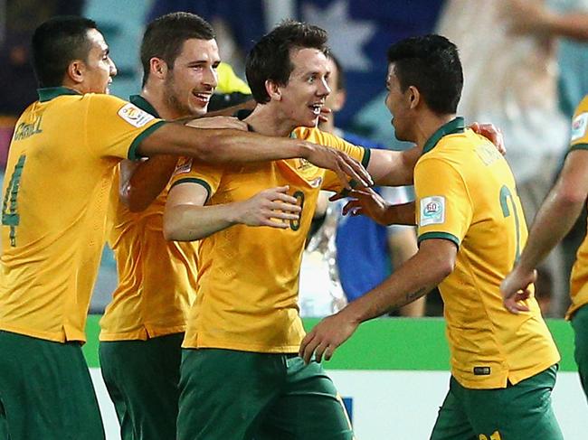 SYDNEY, AUSTRALIA - JANUARY 13: Robbie Kruse of the Socceroos celebrates scoring a goal with team mate Mathew Leckie during the 2015 Asian Cup match between Oman and Australia at ANZ Stadium on January 13, 2015 in Sydney, Australia. (Photo by Cameron Spencer/Getty Images)