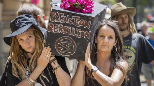 Extinction Rebellion activists stage a mock funeral procession during protests in Brisbane on Thursday. Picture: AAP