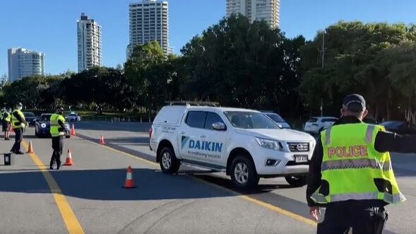 Police stopping vehicles on the Gold Coast Highway to enforce the southeast's Covid lockdown and stop non-essential travel. Picture: 9 News