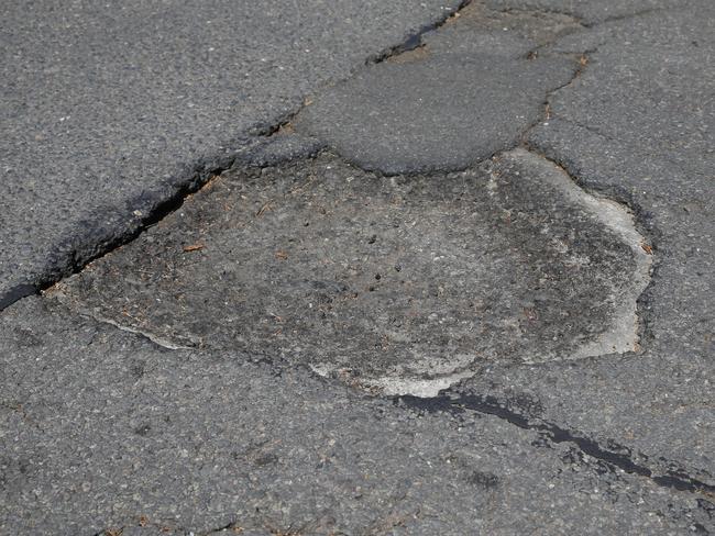 The pothole, similar to this one, wasn’t even that big. Picture: John Appleyard