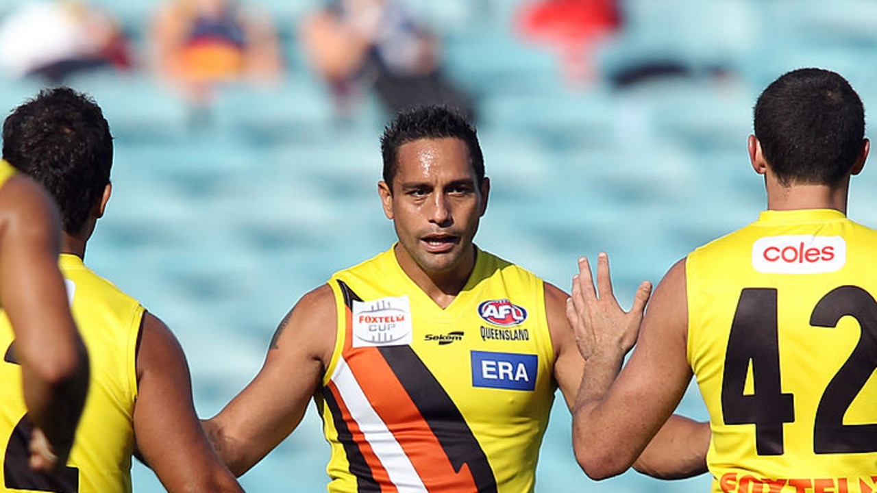 ADELAIDE, AUSTRALIA - MARCH 26: Team mates congratulate Andrew McLeod of the NT Thunder after he kicked a goal during the Foxtel Cup AFL round one match between Morningside and NT Thunder at AAMI Stadium on March 26, 2011 in Adelaide, Australia. (Photo by Morne de Klerk/Getty Images)