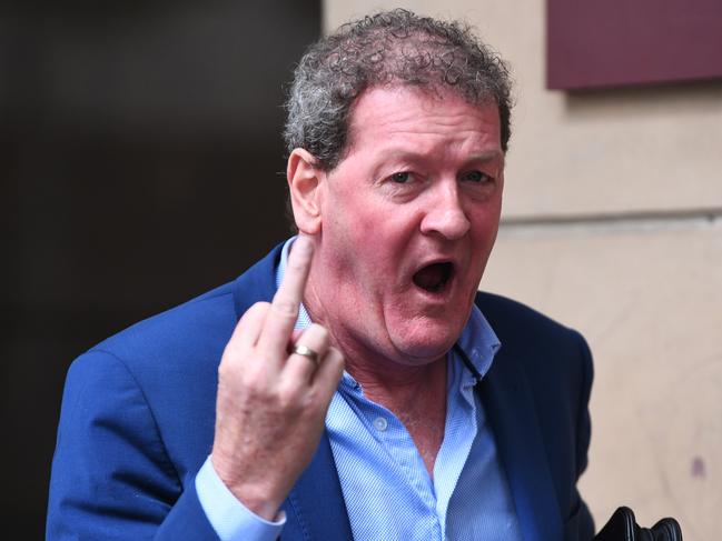 Nixon giving the finger to media after a court appearance in 2018. Picture: AAP