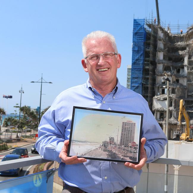 Mike Winlaw is the CEO of the Surfers Paradise Alliance. He is holding an old photo of the Iluka building which was placed into a time capsule and buried on the Surfers foreshore.