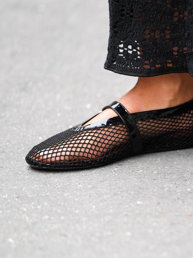 A fashion week guest wears the fishnet mesh version of the Alaia shoes. Picture: Getty Images