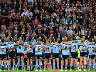 NSW Blues players stand as the national anthem is sung at the start of Game one of the State of Origin series against the Queensland Maroons at Suncorp Stadium in Brisbane, Wednesday, May 31, 2017. (AAP Image/Dan Peled) NO ARCHIVING, EDITORIAL USE ONLY