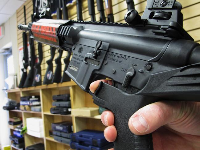 FILE - In this Feb. 1, 2013, file photo, an employee of North Raleigh Guns demonstrates how a "bump" stock works at the Raleigh, N.C., shop. The gunman who unleashed hundreds of rounds of gunfire on a crowd of concertgoers in Las Vegas on Monday, Oct. 2, 2017, attached what is called a "bump-stock" to two of his weapons, in effect converting semiautomatic firearms into fully automatic ones. (AP Photo/Allen Breed, File)