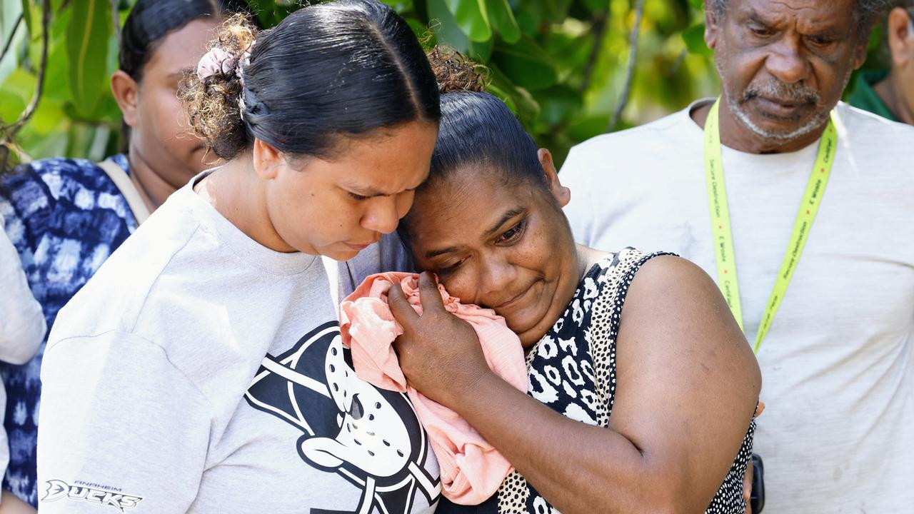 Yarrabah woman Kamaree Major is comforted by relatives Breannen Sands, Paige Fourmile and Eric Sands as she sheds tears for her missing son Markiah Major, 17. Picture: Brendan Radke