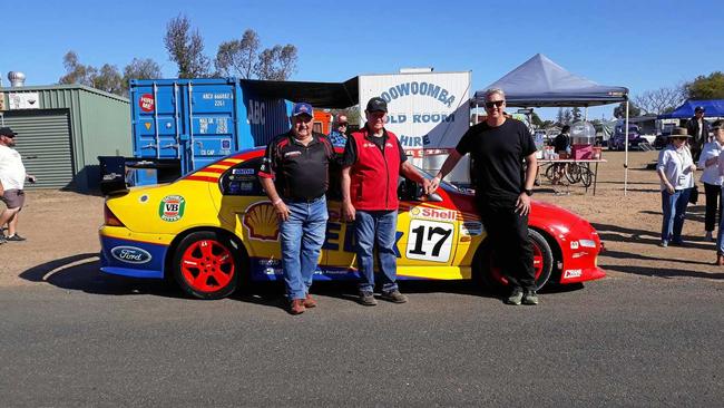 FAST CARS: Keith Edwards, of Withcott, with legend Dick Johnson and son Steve Johnson, in front of Keith's replica car. Picture: Contributed