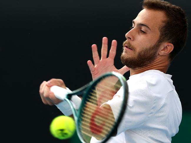 France's Hugo Gaston hits a return against Australia's Omar Jasika during their men's singles match on day one of the Australian Open tennis tournament in Melbourne on January 12, 2025. (Photo b DAVID GRAY / AFP