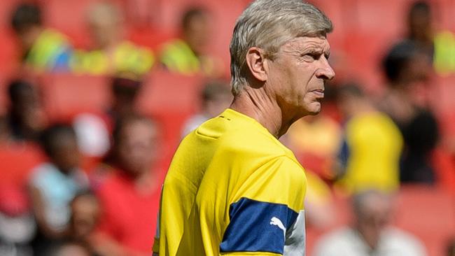 Arsenal Manager Arsenal's French manager Arsene Wenger awaits the arrival of the players for the first team training session at the Emirates stadium in north London, England on August 7, 2014. AFP PHOTO/Leon NEAL - RESTRICTED TO EDITORIAL USE. No use with unauthorized audio, video, data, fixture lists, club/league logos or “live” services. Online in-match use limited to 45 images, no video emulation. No use in betting, games or single club/league/player publications