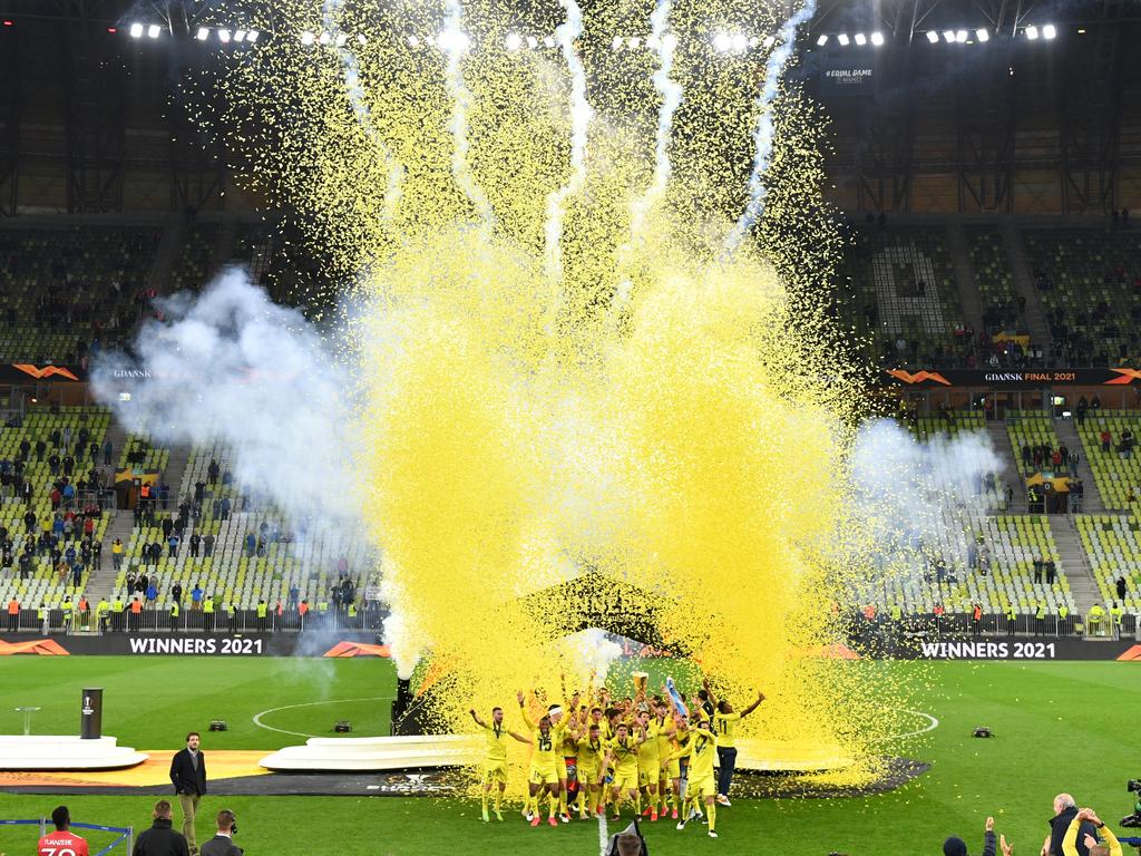 Fireworks go off as Villarreal lift the UEFA Europa League Trophy.