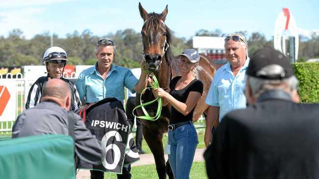 PLACE TO BE: Jockey Michael Cahill joins with connections after winning aboard Temujin's Moon at Ipswich racetrack. Picture: Rob Williams