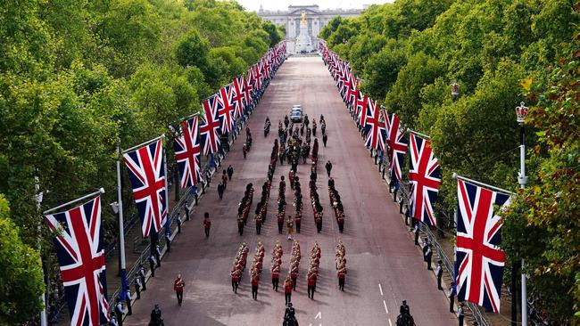 The coffin of Queen Elizabeth II, adorned with a Royal Standard and the Imperial State Crown and pulled by a Gun Carriage of The King's Troop Royal Horse Artillery, during a procession from Buckingham Palace to the Palace of Westminster.