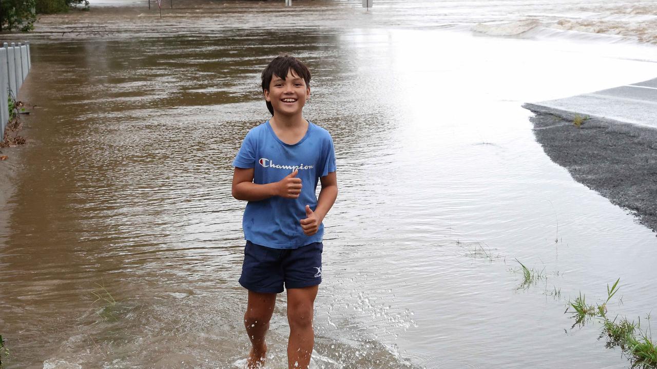 Jack Perris, 11, plays in the flood waters of the Mossman river at the Foxton bridge, TC Jasper. Picture: Liam Kidston