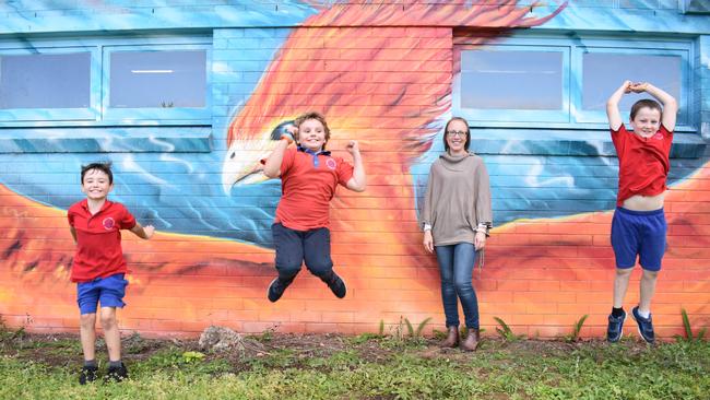 Rappville Public School principal Kat Collis with students in front of their phoenix mural.