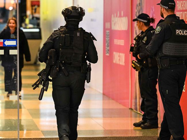 Heavily armed police and the Star Force stand guard at the entrance to the Westfield Marion shopping centre in suburban Adelaide on June 23, 2024, after the mall went into lockdown following a security incident where police say two groups of youths were fighting among themselves. (Photo by MICHAEL ERREY / AFP) / -- IMAGE RESTRICTED TO EDITORIAL USE - STRICTLY NO COMMERCIAL USE --