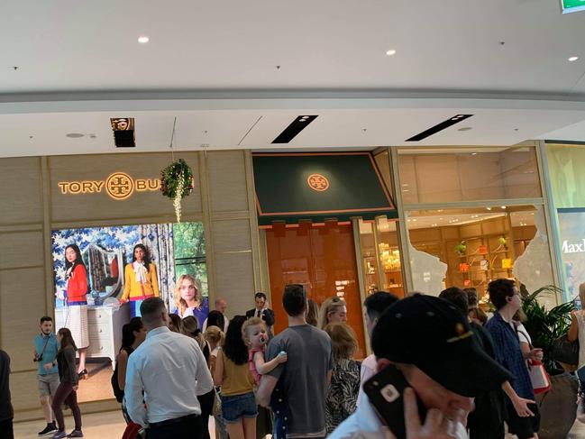 Shocked shoppers outside the Tory Burch store after the window shattered. Picture: Daily Telegraph