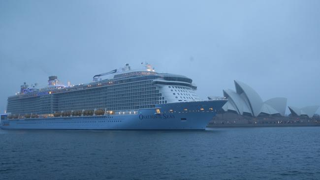 The massive cruise ship Ovation of the Seas has docked in Sydney during a cold wet morning. The rain didn't let up during it's arrival, but that didn't dampen the welcome from Sydney siders who braved the conditions. Pics Bill Hearne