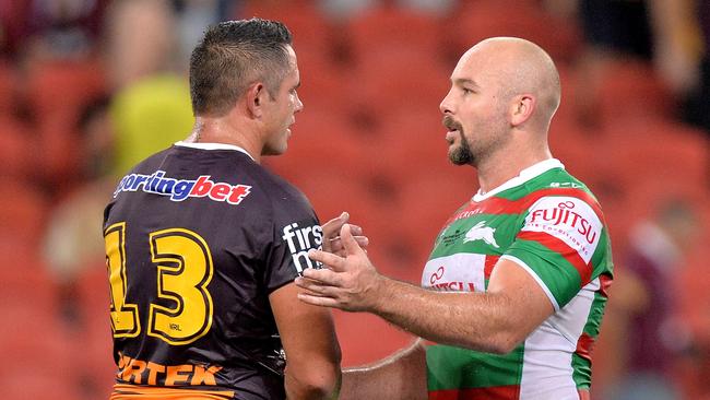 Broncos Corey Parker is congratulated by Glenn Stewart for playing his 300th NRL match after the round one NRL match between the Brisbane Broncos and the South Sydney Rabbitohs at Suncorp Stadium on March 5. Photo: Bradley Kanaris/Getty Image