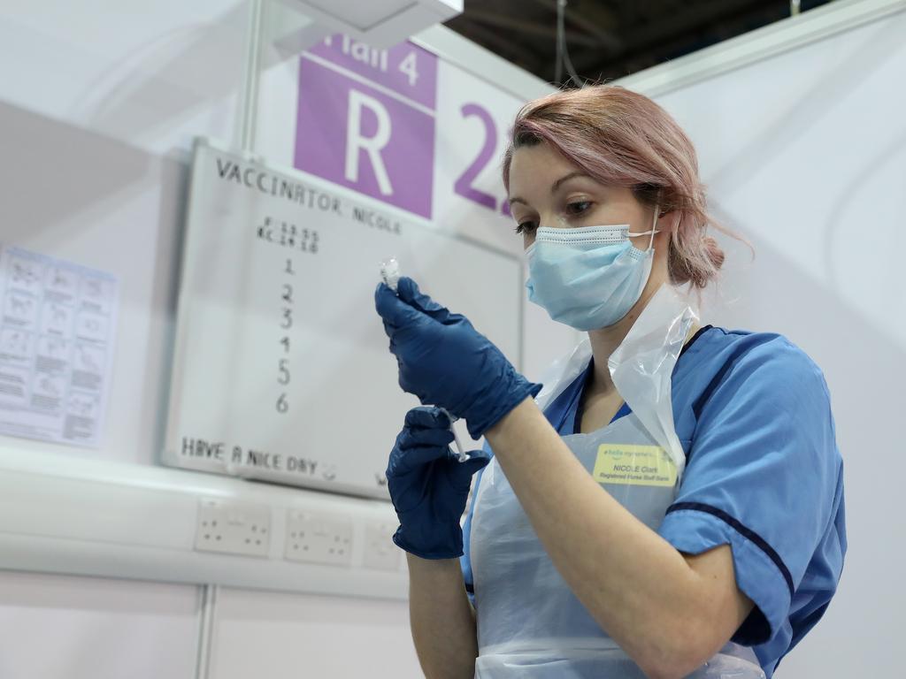 Vaccinator Nicole Clark prepares a COVID-19 vaccination at the NHS Louisa Jordan Hospital in Glasgow, Scotland.