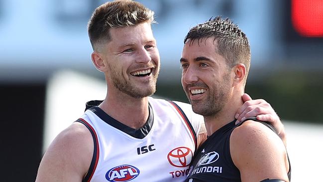 Kade Simpson (right) helped chair his good mate and former Blues teammate Bryce Gibbs off on the weekend after his final AFL match. Picture: Chris Hyde/Getty Images