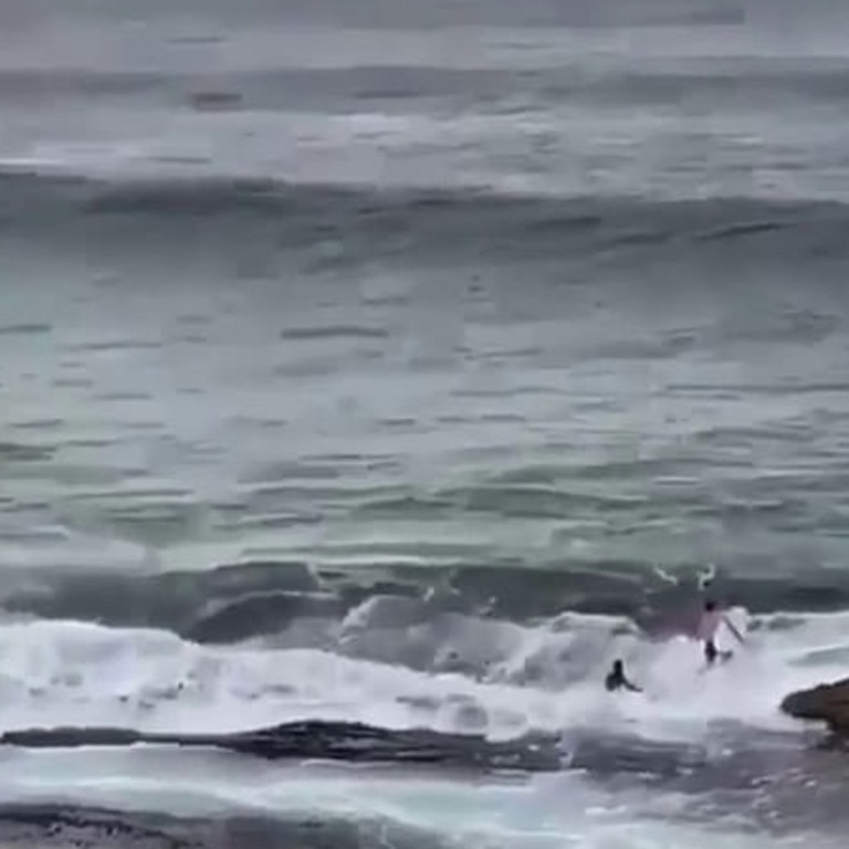 Two surfers have been filmed clambering across a rocky eastern Sydney shoreline in at attempt to get across to the closed Bondi Beach. Picture: Instagram / Bill Morris