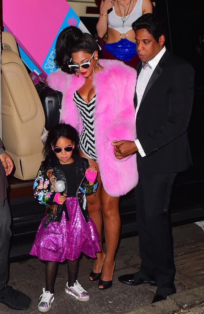 Blue Ivy, wearing pink sequins as only she can, with her parents, Beyonce and Jay Z, on Halloween Picture: Splash
