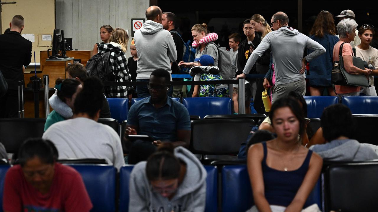 Passengers wait for delayed and cancelled flights off the island. Picture: AFP